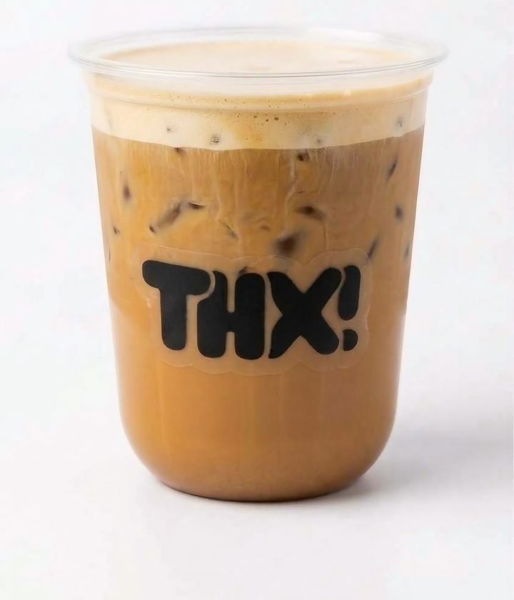 Iced butter pecan latte topped with cold foam in a clear thx! cup