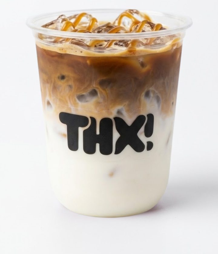 Iced caramel macchiato with a caramel drizzle in a clear thx! cup