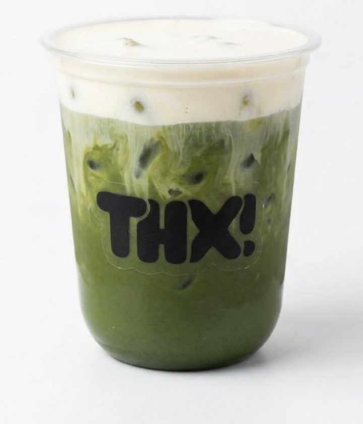 Iced vanilla cream matcha topped with a thick layer of cold foam in a clear thx! cup