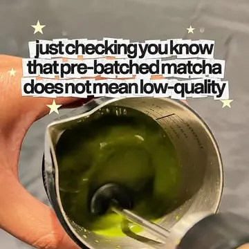 Whisking matcha in a steel pitcher: pre-batched matcha does not mean low quality